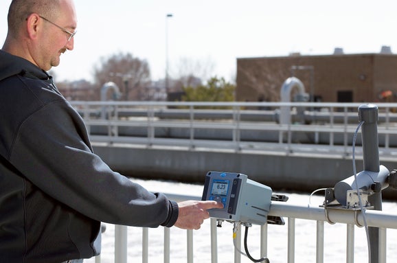 Wastewater treatment facility showing plant operator calibrating SC200 and dissolved oxygen