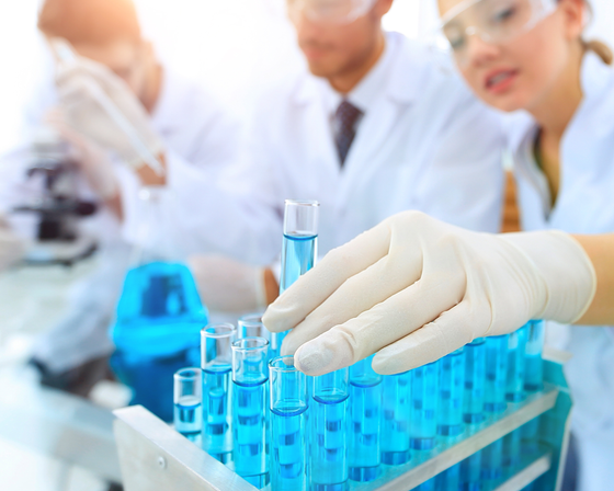 Scientist in a lab holding test tube