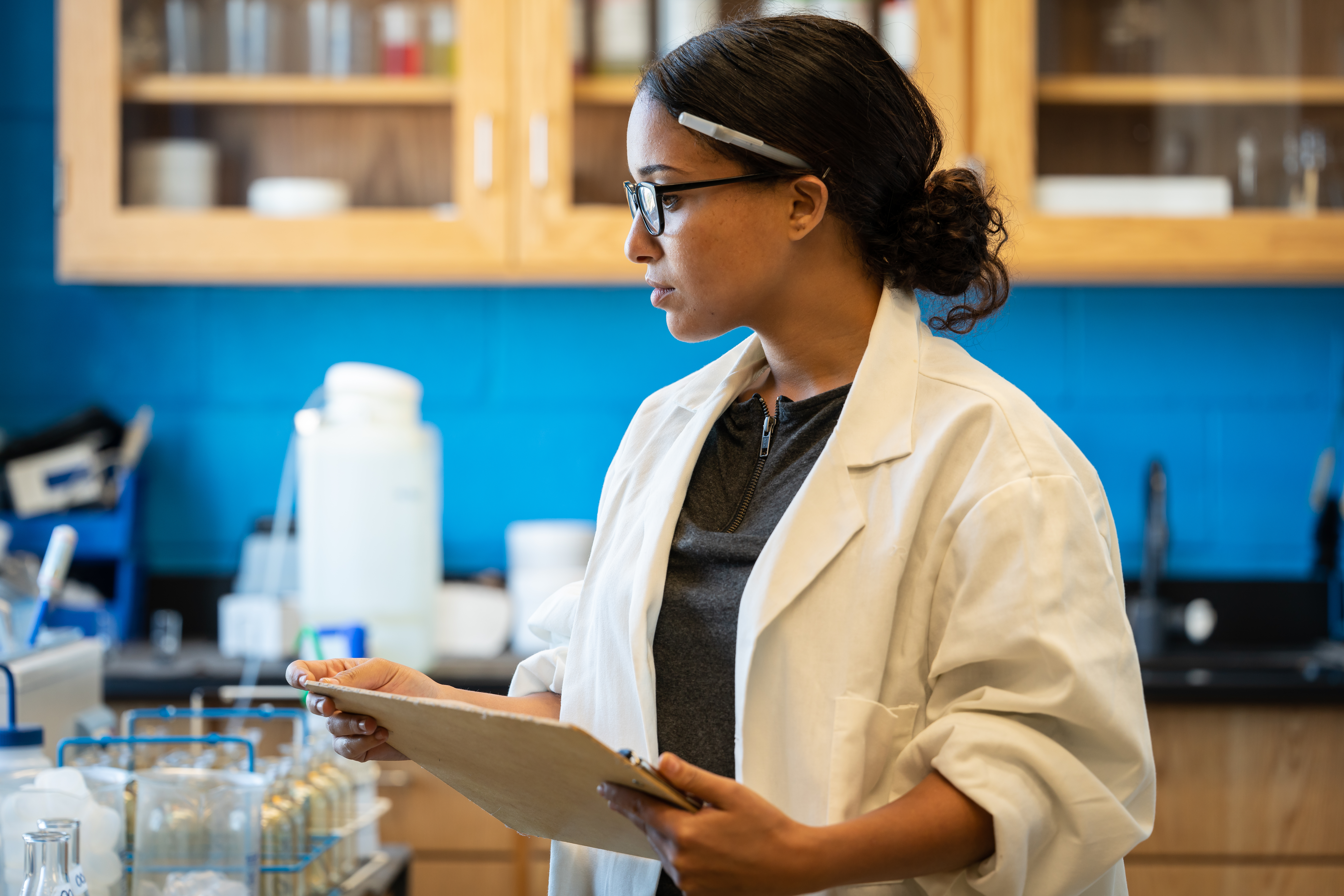 A woman doing an inspection in a lab